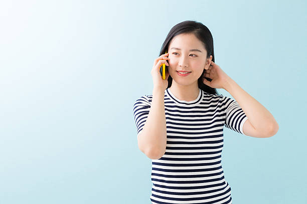 istock Japanese woman talking on a smart phone 619987054