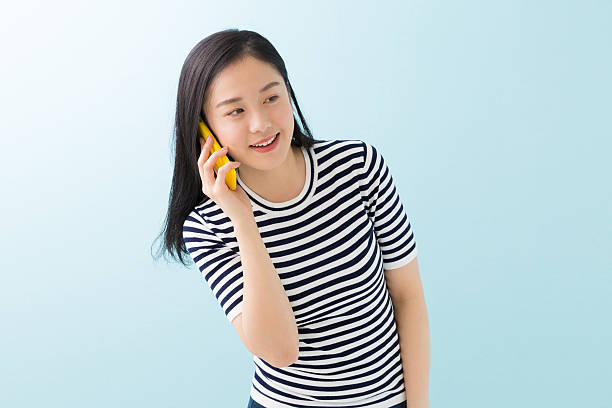 istock Japanese woman talking on a smart phone 619987110