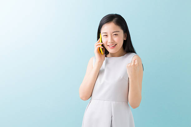 istock Japanese woman talking on a smart phone 619988012