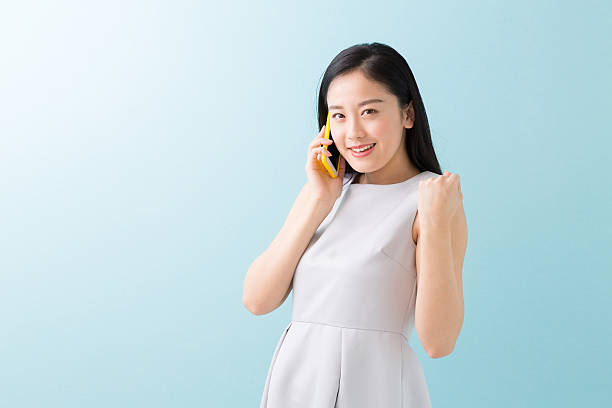 istock Japanese woman talking on a smart phone 619988028