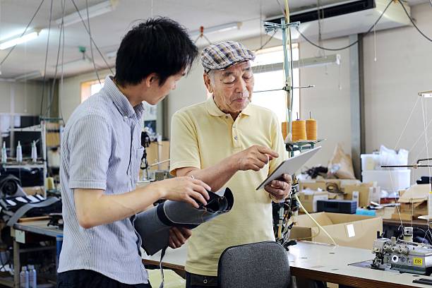 istock Tailors talking about a design of the denim 619991674