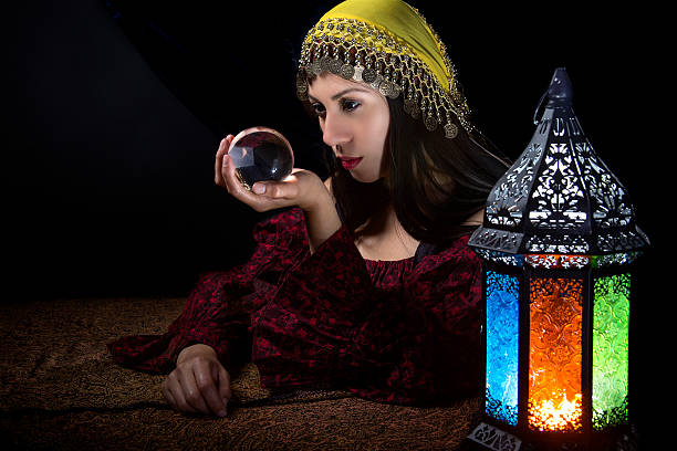 istock Psychic looking into crystall ball 619993804