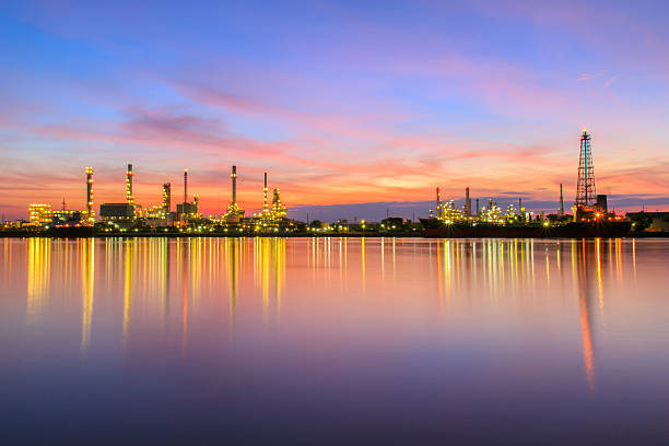 istock Oil refinery along the river at sunrise time 619994320