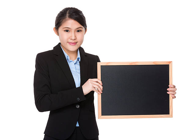 istock Businesswoman holding a chalkboard 619997608