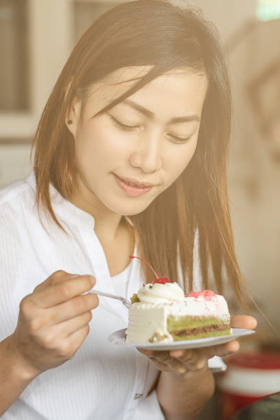 istock Beautiful woman eating cake happily. 619999034
