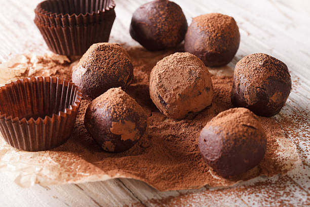 istock French Chocolate truffles with cocoa powder close-up paper. horizontal 620000588
