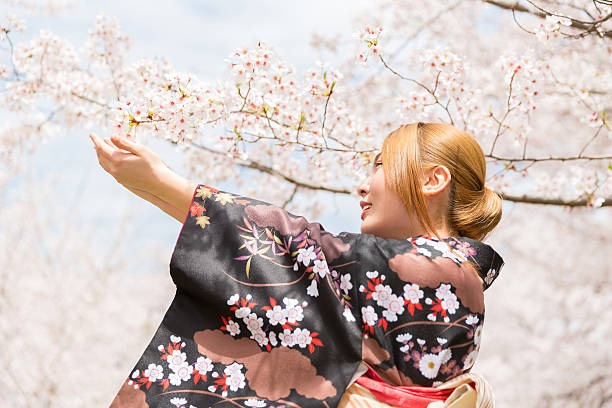 istock Japanese woman wearing kimono with cherry blossom 620001310