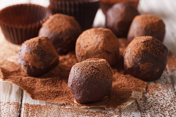 istock Chocolate truffles in cocoa macro on a wooden table. horizontal 620001396