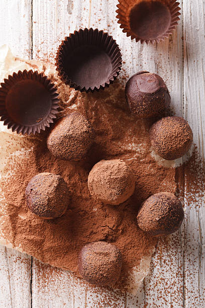 istock Chocolate truffles in cocoa closeup on a table. top view 620001726