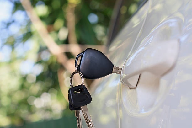 istock Car keys left in the car door 620001920