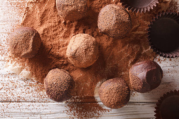 istock Chocolate truffles in cocoa closeup on a table. horizontal 620002310