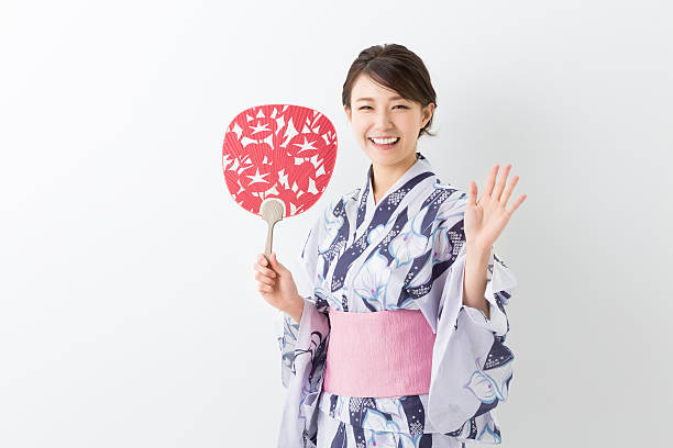 Woman wearing a kimono Woman wearing a kimono yukata photos stock pictures, royalty-free photos & images