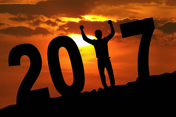 istock Silhouette businessman raising hands with number 2017 620003514