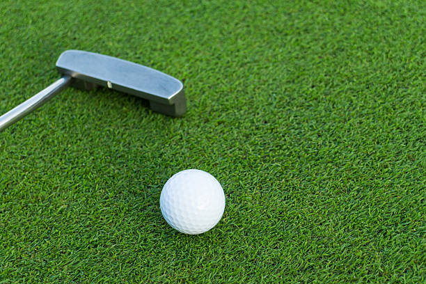 istock Golf ball and golf club 620004804