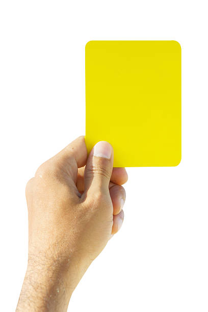 istock Hand of soccer referee showing yellow card 620004892