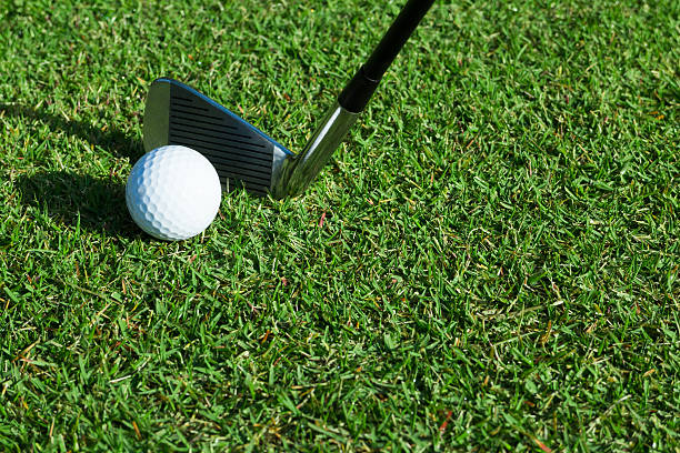 istock Golf ball and golf club 620005244