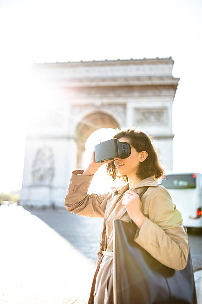 istock woman using a Virtual reality simulator in paris 620006634