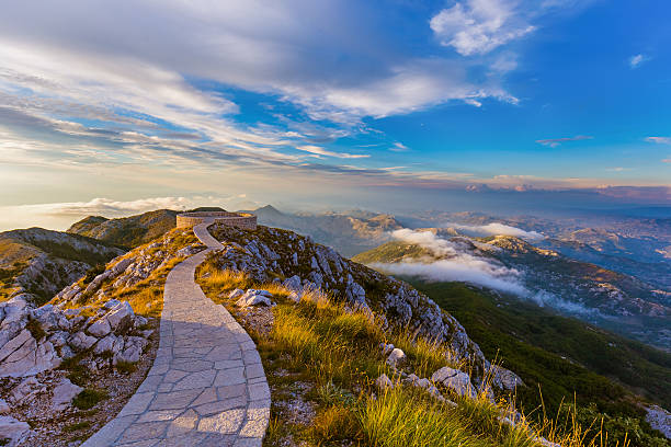 Lovcen Mountains National park at sunset - Montenegro Lovcen Mountains National park at sunset in Montenegro panoramic country road single lane road sky stock pictures, royalty-free photos & images