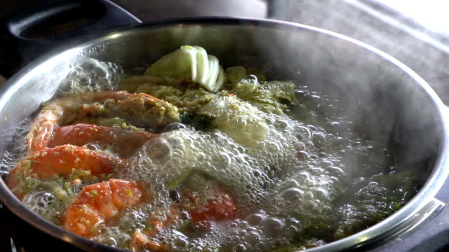 Slow motion: Cooking of spicy seafood soup hot pot