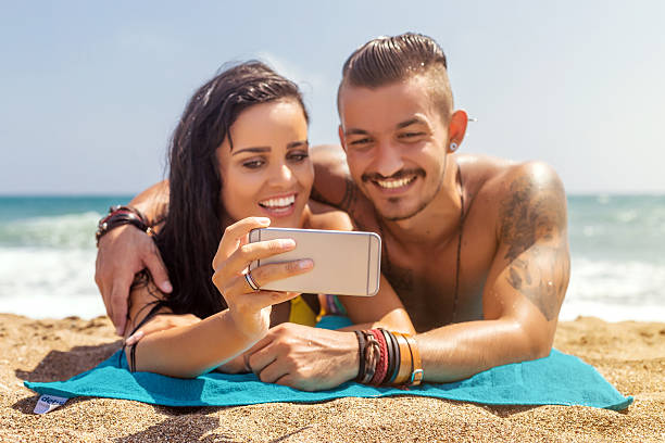 istock Young couple in swimwear taking selfie on summer beach 620367206