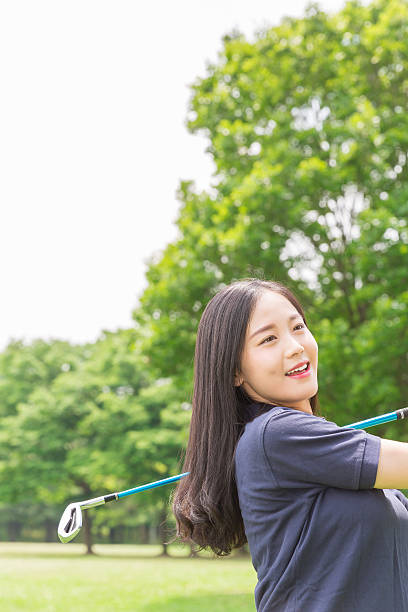 istock Japanese woman playing golf 620367332