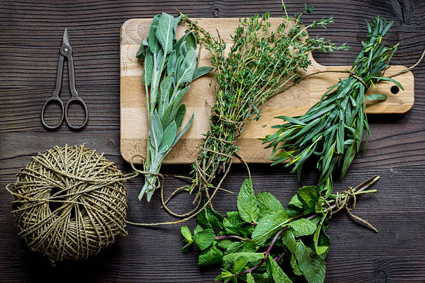 istock bundle of sage and thyme on wooden board top view 620368426