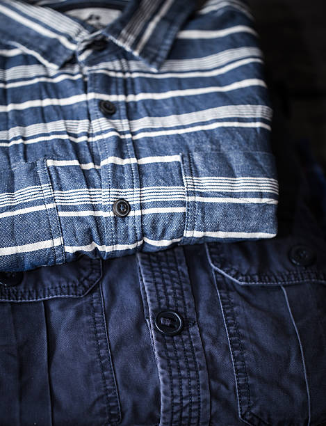 istock stylish men's clothing, shirts folded in a pile 620369252