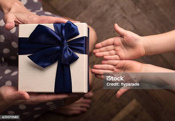 Mother Giving A Big Gift Boxes To Her Kid Stock Photo - Download Image Now - Gift, Child, Giving