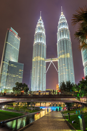 Night scene with crowd people watching lights show of Petronas Twin towers at Suria KLCC fountain, Kuala Lumper, Malaysia.