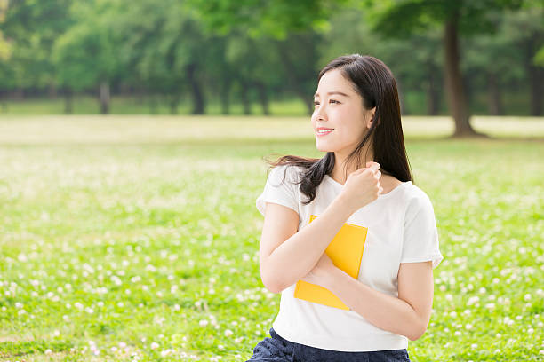 istock Japanese woman reading a book 620371162