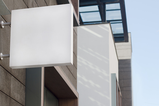 Horizontal front view of empty square signage on a building with modern architecture