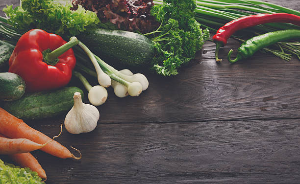 istock Border of fresh vegetables on wooden background with copy space 620373780