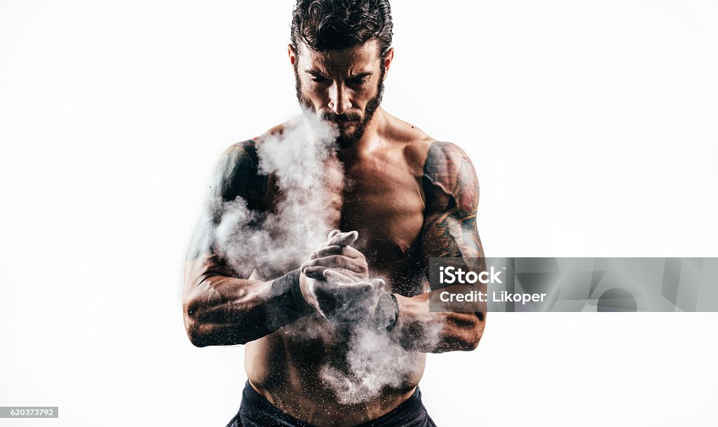 Strength Portrait of a man with perfect muscular built. Man is good looking. He is wearing a beard. Cross Training Stock Photo