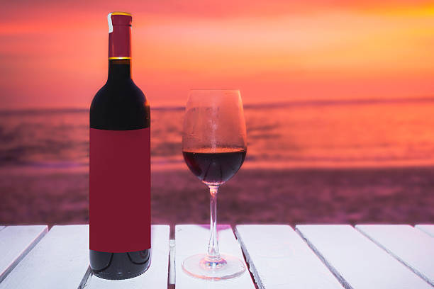 istock Wine bottle and glass with sunset backgrounds 620375782