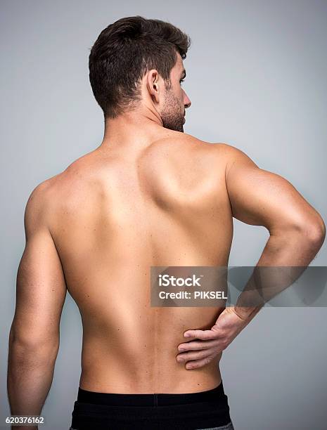 Man With Back Pain Stock Photo - Download Image Now - Rear View, Men, Back