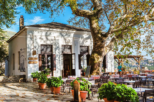 Street and cafe view at Makrinitsa village of Pelion, Greece Makrinitsa, Greece - October 11, 2016: Street and cafe view at Makrinitsa village of Pelion, Greece pilio greece stock pictures, royalty-free photos & images