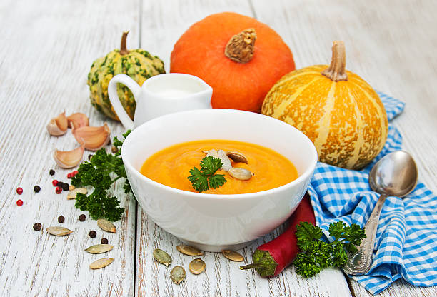 istock Pumpkin soup with fresh pumpkins 620378008