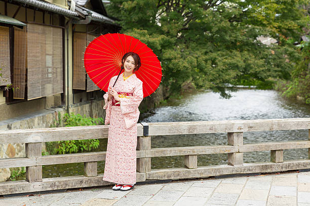 istock Woman wearing a kimono with a red umbrella 620378018