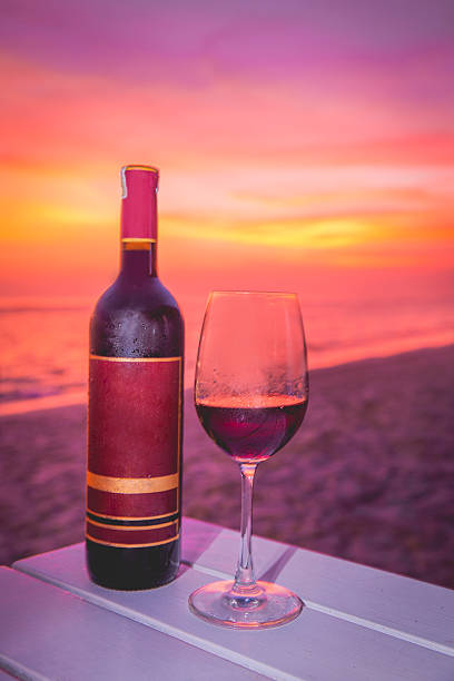 istock Close up of wine bottle with sunset backgrounds 620378702