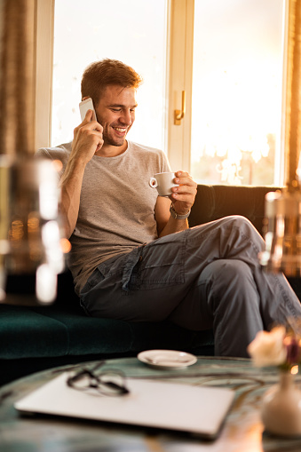 Smiling Man Making A Phone Call While Drinking Coffee Stock Photo - Download Image Now - iStock