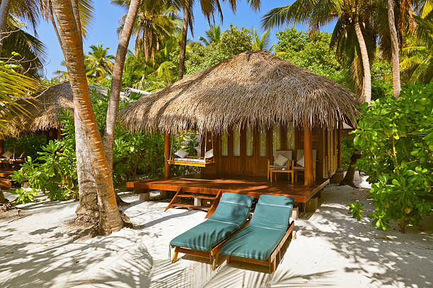 Beach bungalow - Maldives Beach bungalow - Maldives vacation background water bungalow maldives stock pictures, royalty-free photos & images