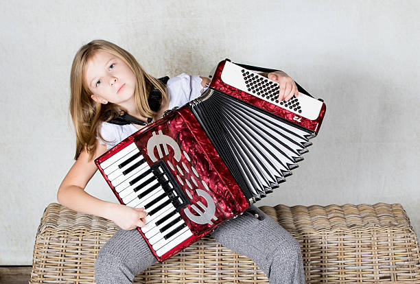 istock Girl seriously playing an Accordion 620381048