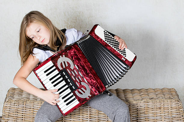 istock Firl focusing on playing an accordion 620381292