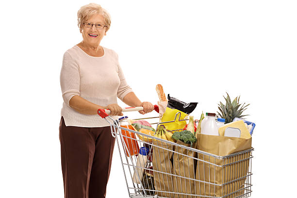 istock Cheerful mature lady with shopping cart 620381732