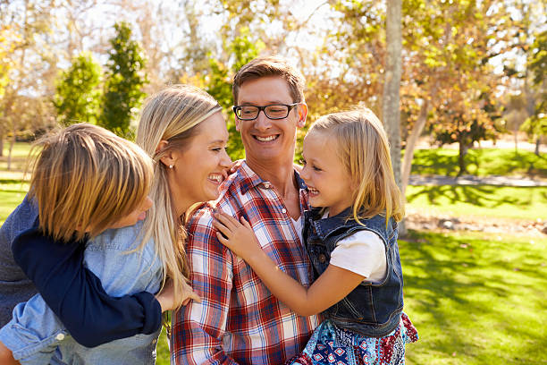 istock Young white family having fun together in a park 620381932