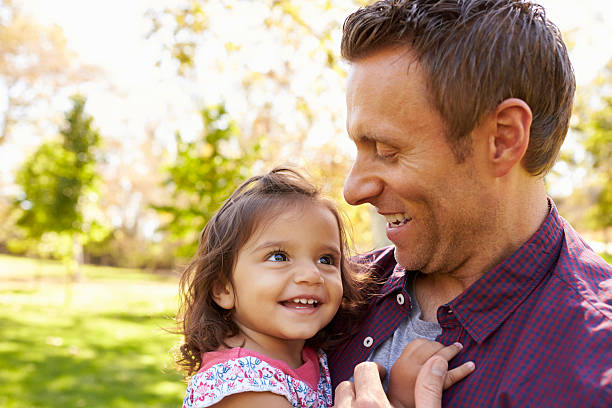 istock White dad holding his young mixed race daughter in 620382156