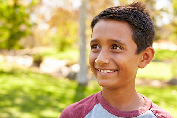 istock Smiling mixed race Caucasian Asian boy in park looking away 620382270
