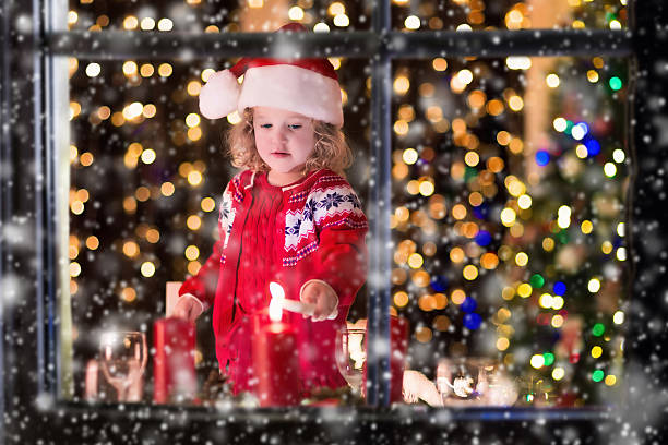 istock Little girl lighting candles at Christmas dinner 620382376