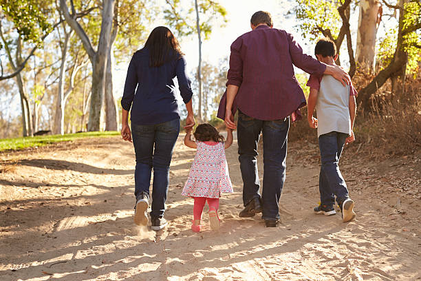 istock Mixed race family walking on rural path, close up 620382634