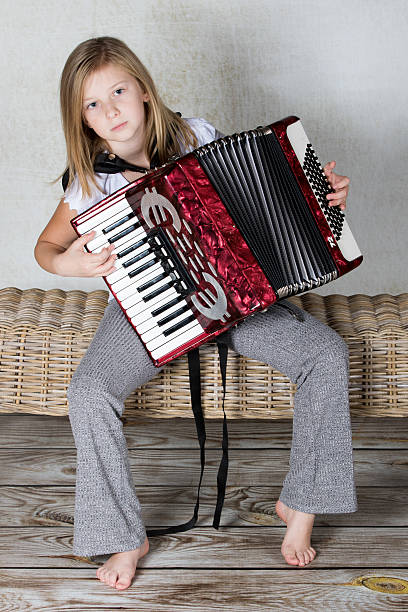 istock Girl focused on playing the accordion 620383312